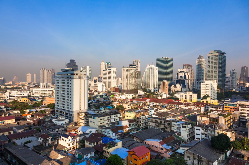Contrast between new and holding buildings in Bangkok, Thailand