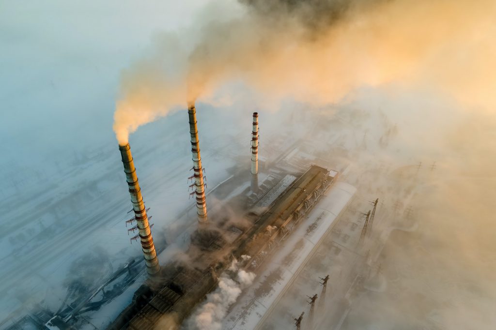 Aerial view of coal power plant high pipes with black smoke