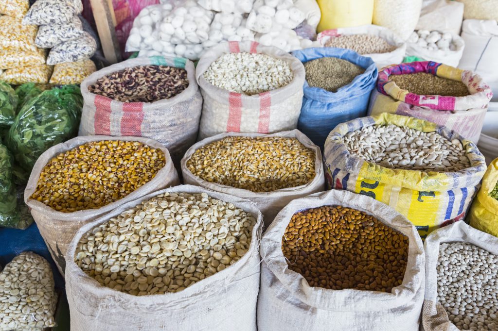 Peru, Cusco, market Mercado Central de San Pedro, sacks with cereals, beans, lentils and corn