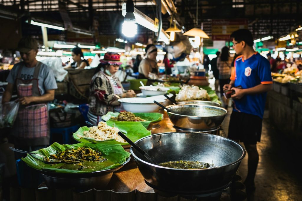 man in blue shirt standing in front of counter